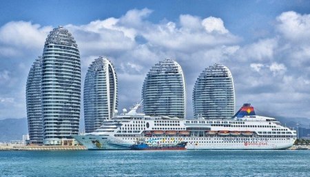 cruise-ship-in-bay-with-skyscrapers-in-background.jpg